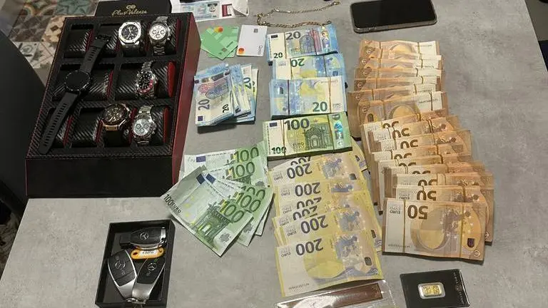 Una parte del materiale posto sotto sequestro dalla Finanza e dai carabinieri: denaro, oro, orologi e auto di lusso