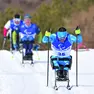 Giuseppe Romele in azione in una gara di sci di fondo paralimpico, nel riquadro Marco Giunio De Sanctis