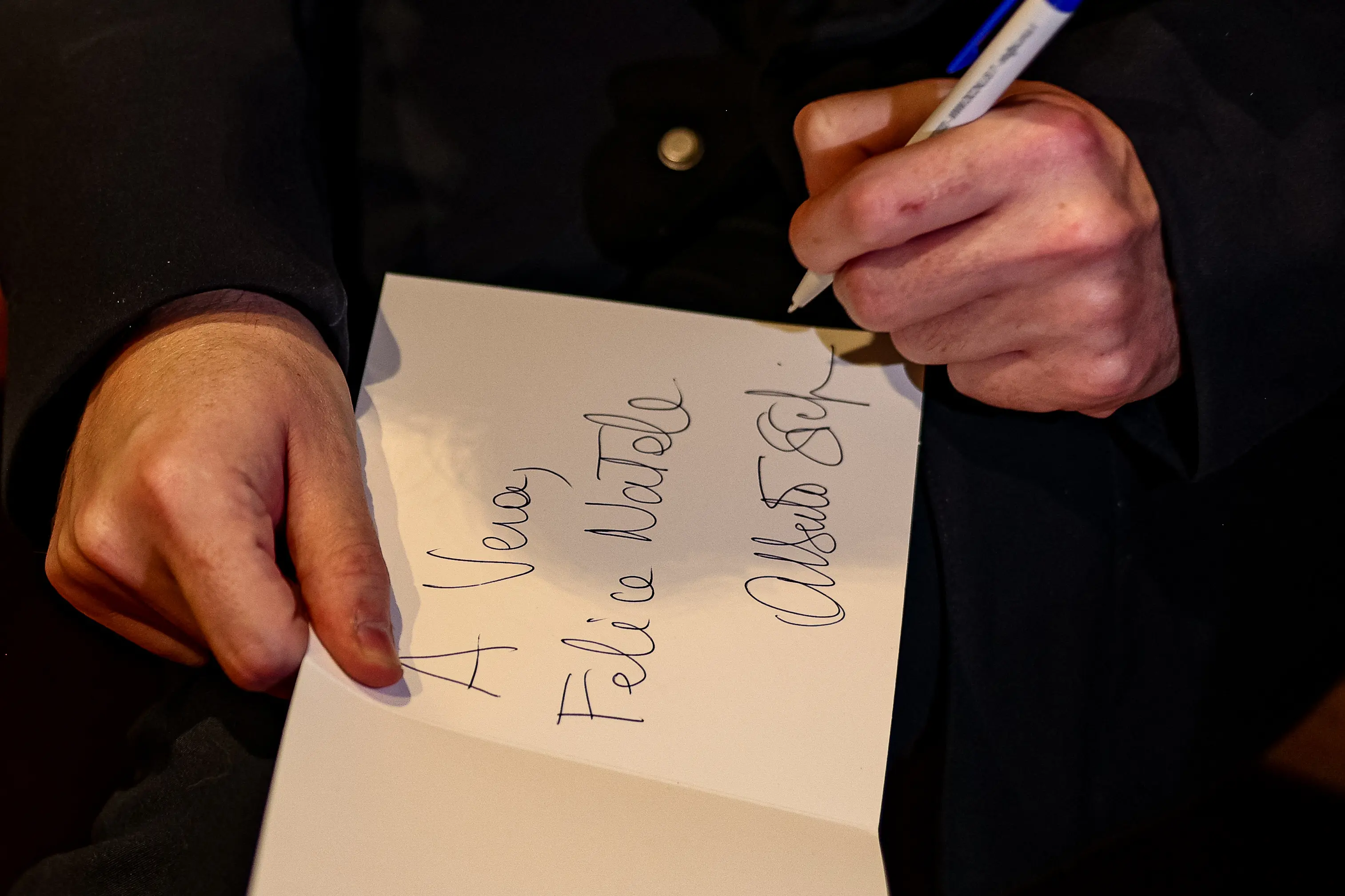 Il presidente della Regione Veneto Alberto Stefani mentre firma i bigliettini di Natale per i bambini