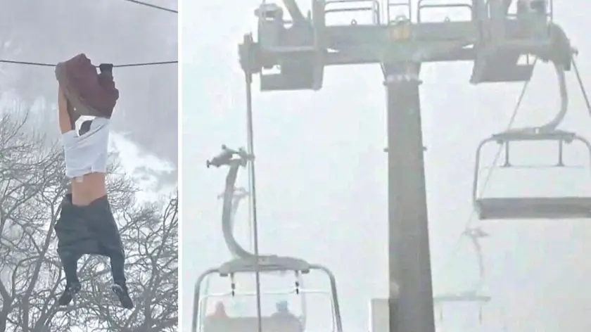 Nel fermo immagine trasmesso da Telefriuli il 32enne aggrappato ai cavi della seggiovia