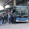 Un gruppo di studenti alla stazione dell'autobus