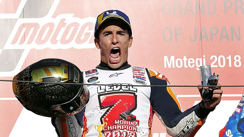 epa07108778 Spanish MotoGP rider Marc Marquez of Repsol Honda Team celebrates on podium after winning the MotoGP Motorcycling Grand Prix of Japan and World Champion 2018 title at Twin Ring Motegi, Tochigi Prefecture, northern Japan, 21 October 2018. EPA/KIMIMASA MAYAMA