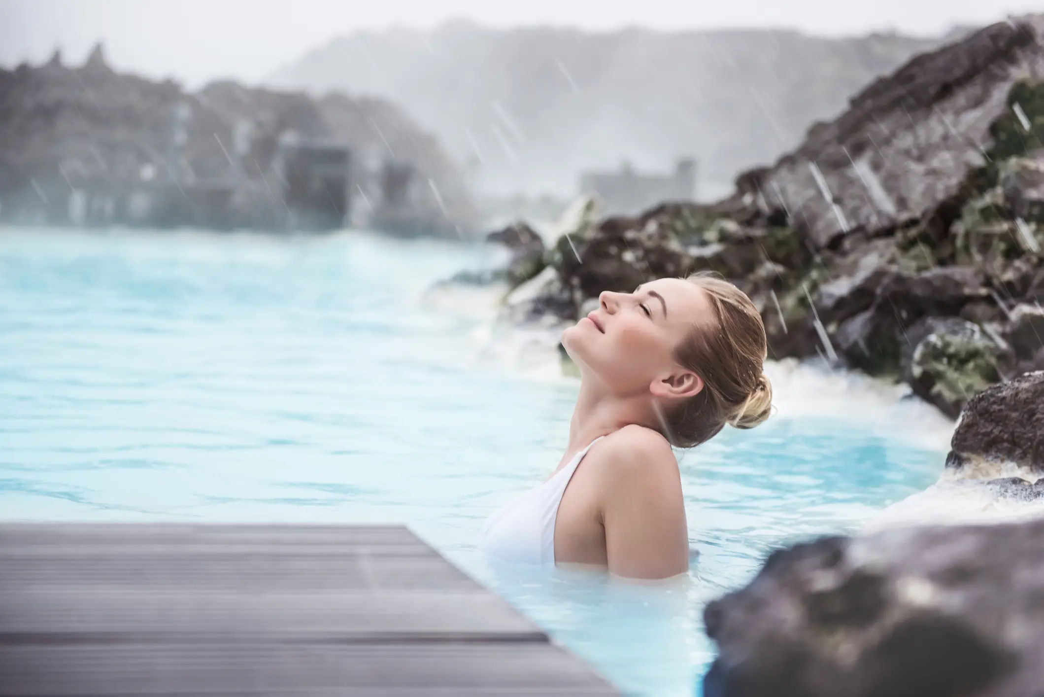 Woman enjoying natural spa, Blue Lagoon is a geothermal spa in southwestern Iceland, is located in a lava field near Grindavk on the Reykjanes Peninsula