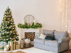 Christmas decorations and a garland on the tree with a home interior