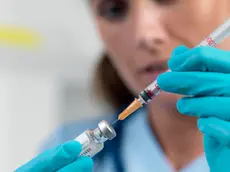 Doctor filling a syringe