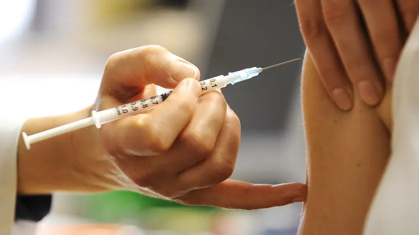 A woman receives a swine flu vaccine in the eastern German city of Dresden on November 4, 2009. Tiny infants are most likely to be hospitalized with swine flu, but people over the age of 50 are most at risk of dying in hospital from the disease, US researchers said. AFP PHOTO DDP / NORBERT MILLAUER GERMANY OUT (Photo credit should read NORBERT MILLAUER/AFP/Getty Images)