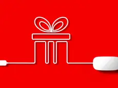 White mouse cable forming a gift box on red background. Horizontal composition with copy space.