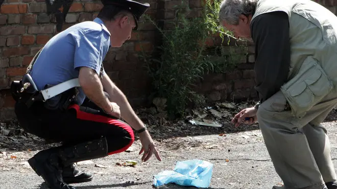 20080618 - TORINO - CLJ - TROVATO FETO IN SACCO NYLON A TORINO. Carabinieri sul luogo dove è stata trovato un feto di 5-6 mesi in un sacchetto di nylon, questa mattina in corso Settembrini, nei pressi della porta 9 dello stabilimento di Fiat Mirafiori, a Torino. Il corpicino e' stato trovato probabilmente da un impiegato della Fiat mentre entrava al lavoro, attorno alle 8. La sua attenzione e' stata attirata dalla presenza di una cornacchia che beccava il piccolo corpo. Accanto al feto e' stato trovato un sacchetto con dentro il cordone ombelicale. Tutt'intorno immondizia di ogni genere, bottiglie di vetro, cartone,oggetti in plastica. Il medico legale Enrico Astore non ha potuto accertare il sesso, ma soltanto stabilire che e' di razza bianca e che la madre, circa al quinto mese di gestazione, lo ha partorito nella notte nei pressi del luogo di ritrovamento, forse in un'auto. ANSA/TONINO DI MARCO/DRN